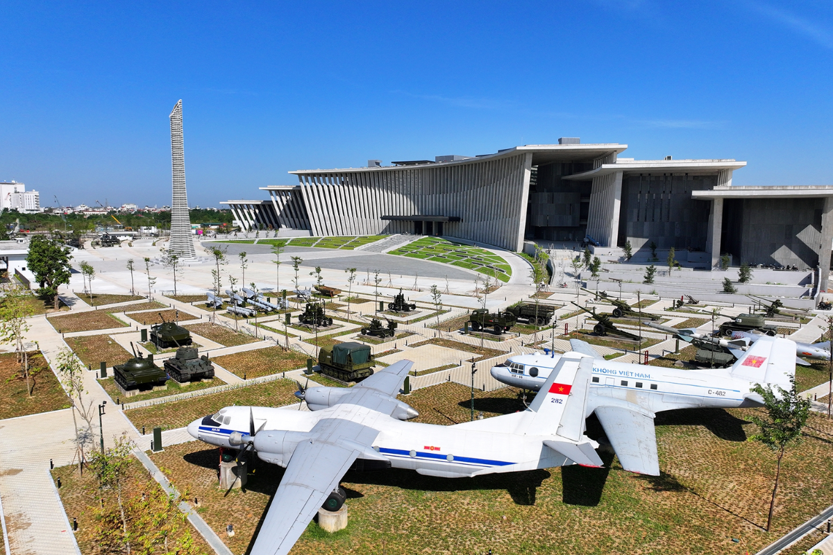 Interior view of Vietnam Military History Museum showing MiG-21 fighter jet suspended above the main hall, a symbol of Vietnam's victory against American air forces.